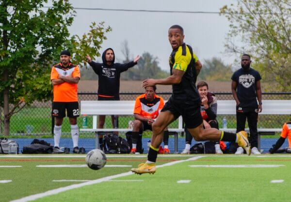 2025 BAS Cup Action : 905 FC's bench looks on as their defense faces a potential counter attack.