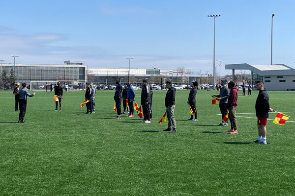 Ontario Match Official Certification candidates learning flag usage and techniques for working the lines.